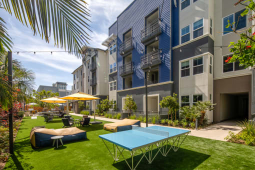 a courtyard with a ping pong table and lounge chairs at Citron, Anaheim, 92805