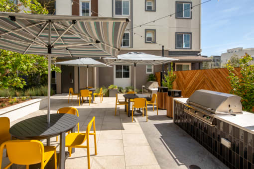 an outdoor patio with tables and chairs and a grill at Citron, Anaheim, 92805