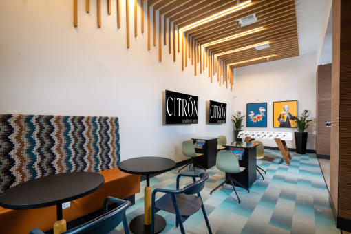 a room with tables and chairs and paintings on the wall at Citron, California