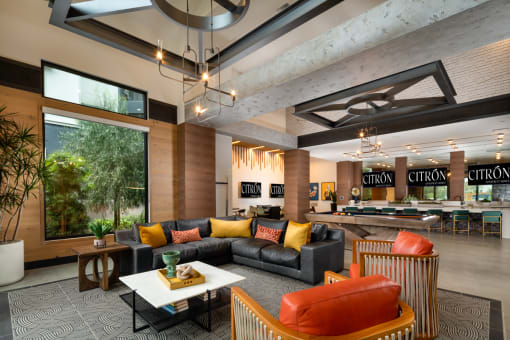 a living room filled with furniture and a large window  at Citron, Anaheim, CA