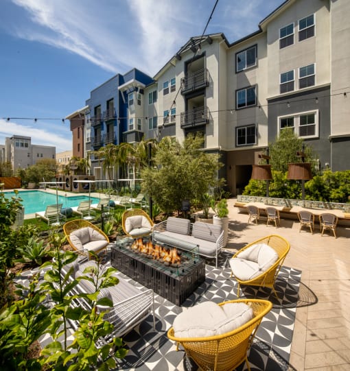 an outdoor lounge area with lounge chairs and a fire pit  at Citron, Anaheim, CA