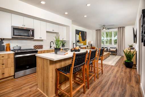 A modern kitchen with wooden floors and a large island.