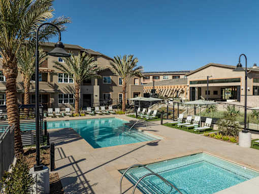 A pool area with a large building in the background.