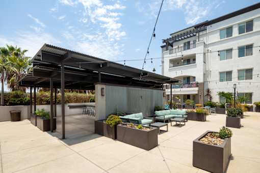 A patio area with a bar and seating area.