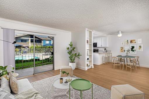 A living room with a green chair and a white couch.