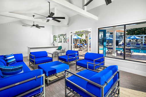A room with blue chairs and a ceiling fan.