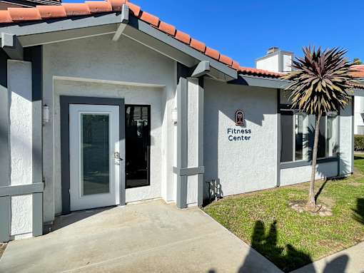 A small building with a sign that says Fitness Center.