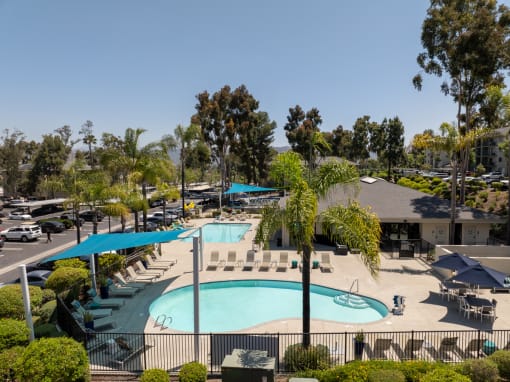 a view of a pool and pool chairs
