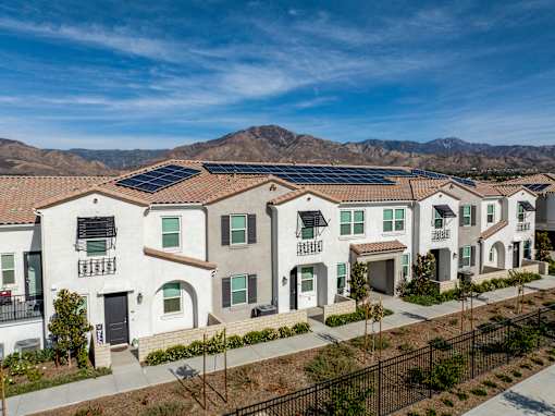 A row of houses with solar panels on the roofs at San Carlo Townhomes Apartments, California