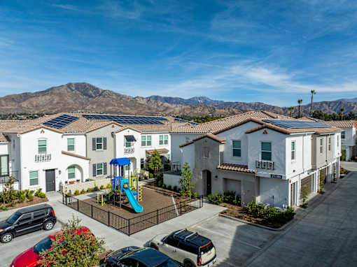 A sunny day at a residential complex with solar panels on the roofs at San Carlo Townhomes Apartments, Highland, CA, 92346