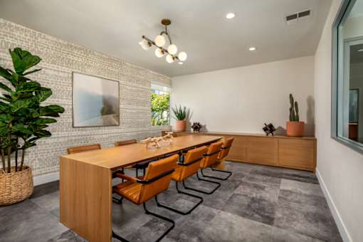 A conference room with a long table and chairs.