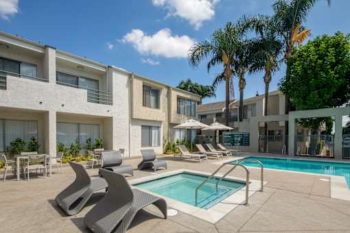 A pool area with a white building in the background.