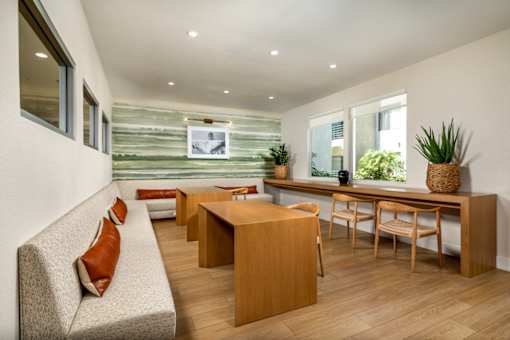A living room with a couch, chairs, and a table.