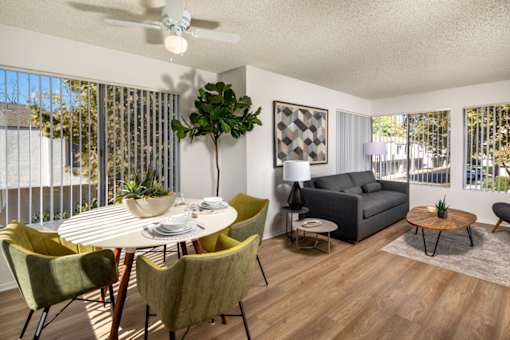 A living room with a dining table and chairs.