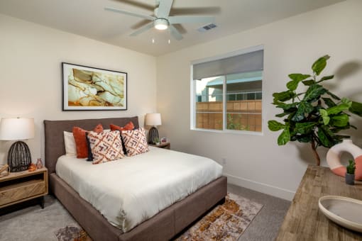 a bedroom with a bed and a ceiling fan
