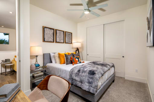 a bedroom with a bed and a ceiling fan