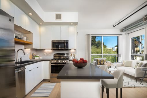 a kitchen with white cabinets and stainless steel appliances  at The LC, Los Angeles