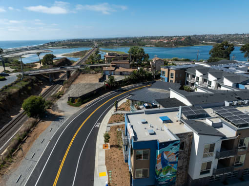 an aerial view of an empty street with houses and a train