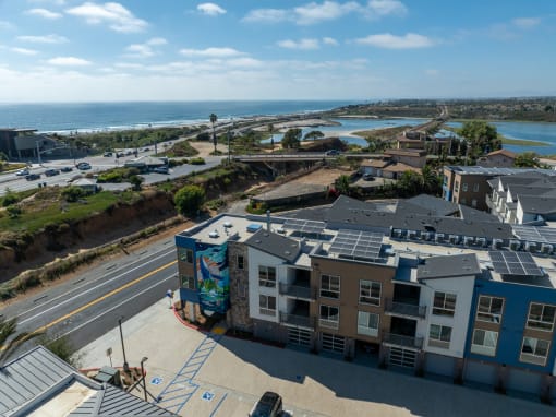 an aerial view of an apartment building with solar panels on the roof