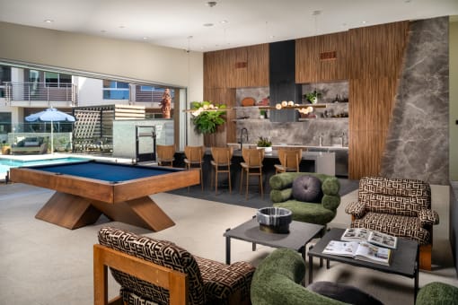 a living room with a pool table and a dining table