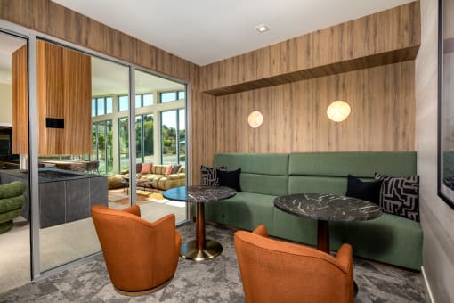 a living room with a green couch and two tables