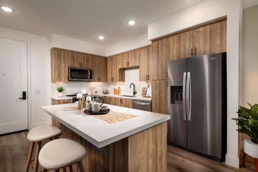 a kitchen with stainless steel appliances and a marble counter top