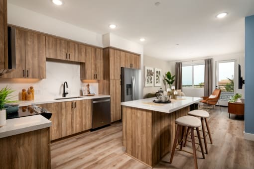 a kitchen with wooden cabinets and a large island with stools