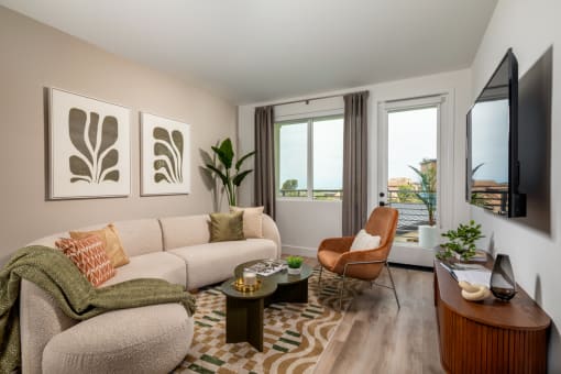 a living room with a couch and a chair and a tv