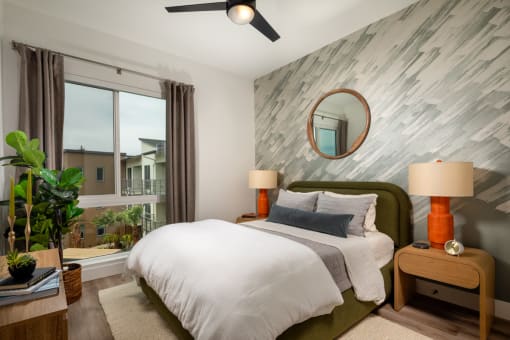 a bedroom with a large bed and a large window