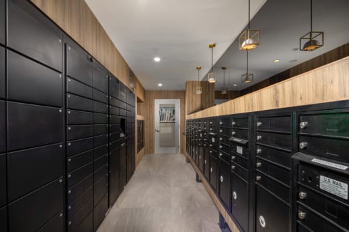 a long hallway with black mailboxes and wooden walls
