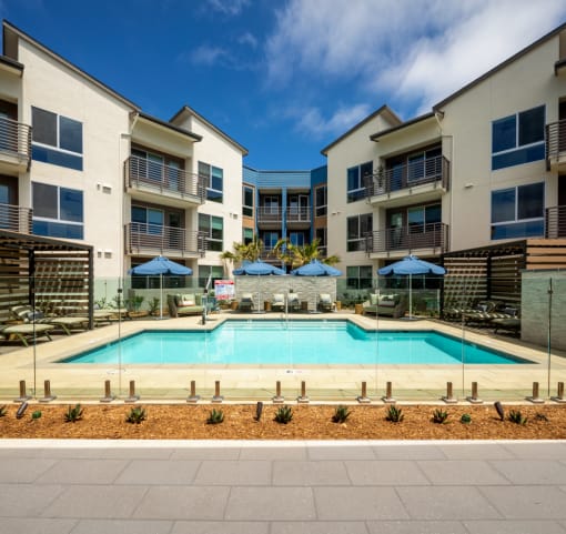 a swimming pool in front of an apartment building
