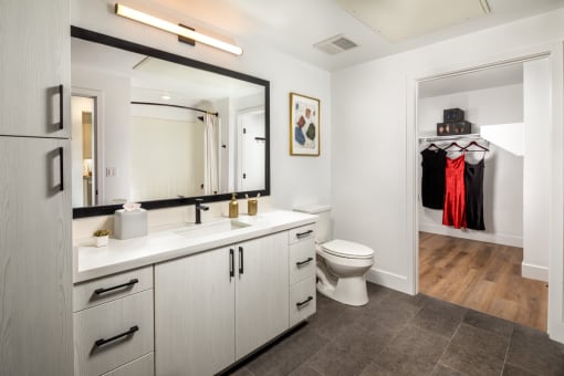 a bathroom with white cabinets and a large mirror at VORA LUX, San Diego, 92120