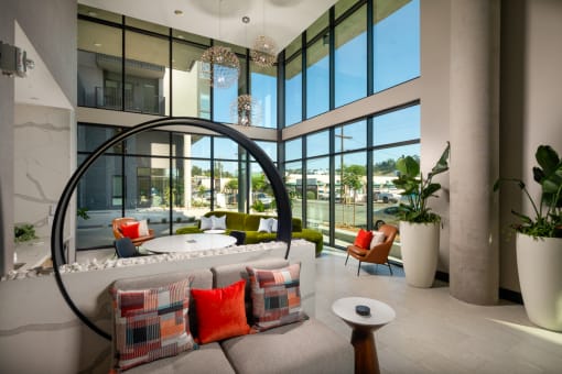 a living room filled with furniture and a large window at VORA LUX, San Diego