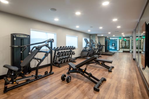 a room filled with weights and other exercise equipment at VORA LUX, San Diego, 92120