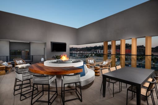 a terrace with a fire pit and a table with chairs at VORA LUX, California, 92120