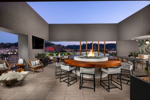 a patio with a fire pit and a view of a city at night at VORA LUX, California