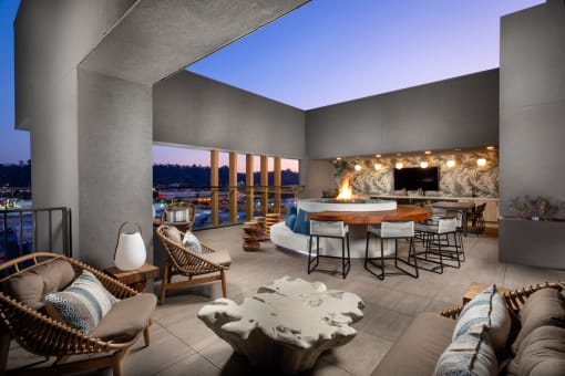 a living room filled with furniture and a fire pit at VORA LUX, San Diego, 92120