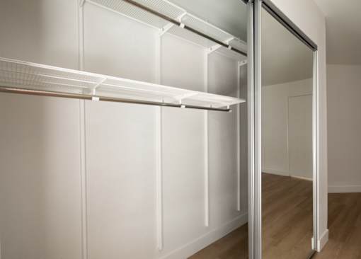 A white refrigerator with its door open in a room.