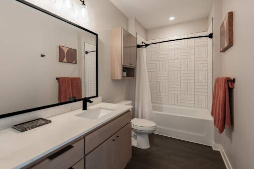 A bathroom with a white sink, toilet, and bathtub.