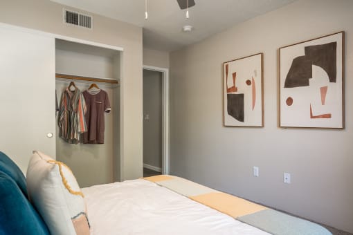 a bedroom with a bed and two paintings on the wall at Odyssey Ridge, Albuquerque