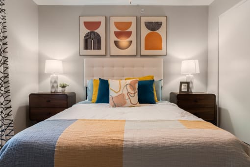 a bedroom with a bed and two night stands with lamps at Odyssey Ridge, New Mexico