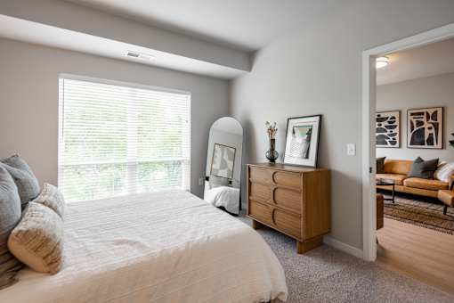 A bedroom with a large bed and a dresser.