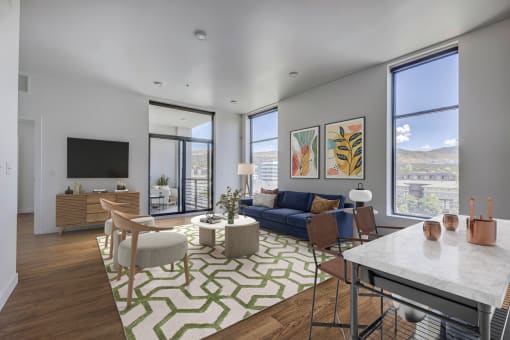 Furnished living room with large windows and wood floors