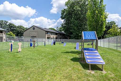 a playground with a swing set and a tennis court