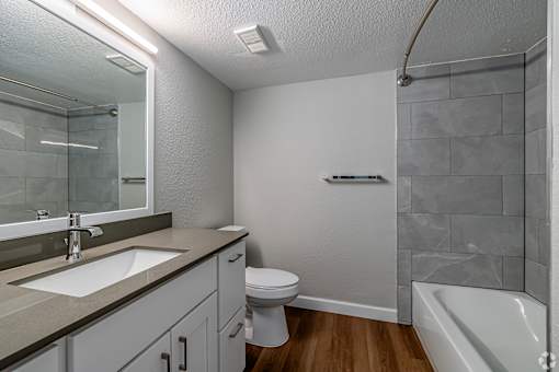 a bathroom with a sink toilet and a shower