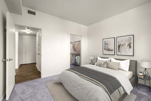 A bedroom with a large bed and two framed pictures on the wall.