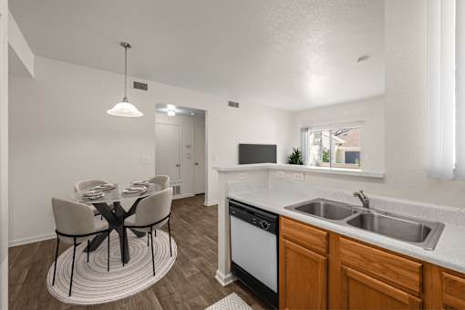 A modern kitchen with a dining table and chairs.