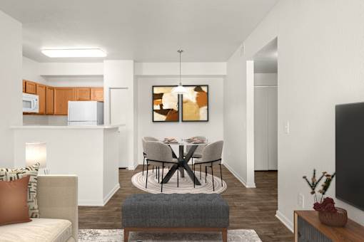 A modern living room with a grey ottoman and a black chair.