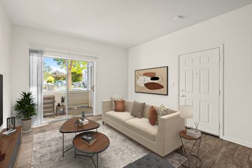 A living room with a couch, a coffee table, and a painting on the wall.