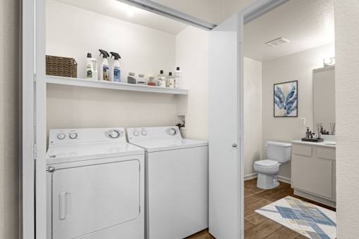 A laundry room with a washer and dryer stacked on top of each other.